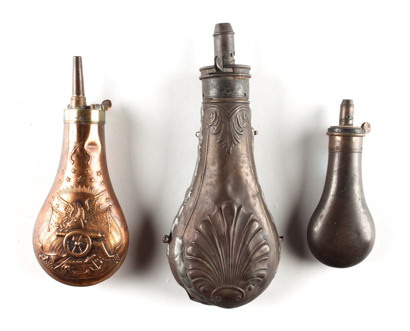 Appraisal: Three powder flasks including one with ornate American patriotic design