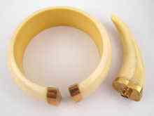 Appraisal: An ivory bangle and an ivory pendant both with yellow