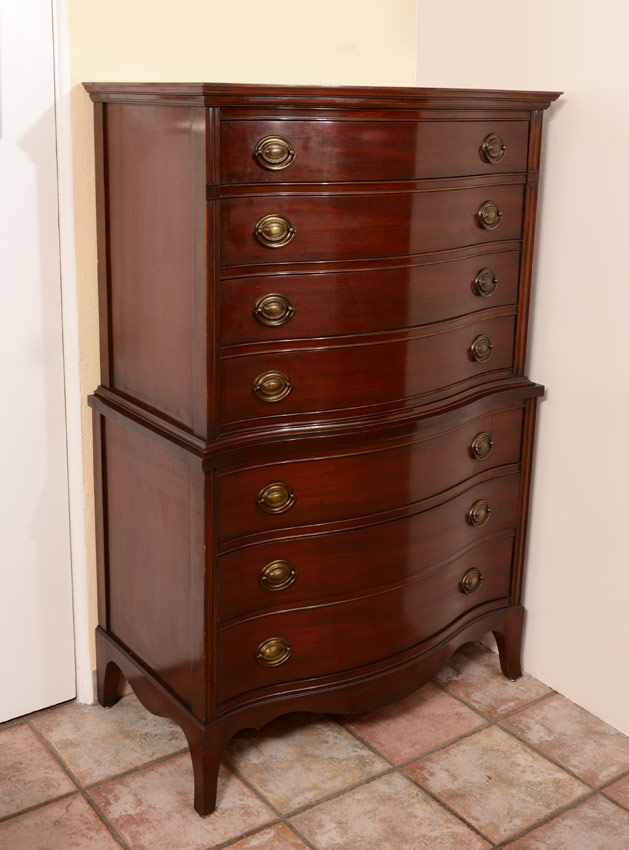 Appraisal: A TRADITIONAL MAHOGANY TALL CHEST drawer serpentine front tall chest