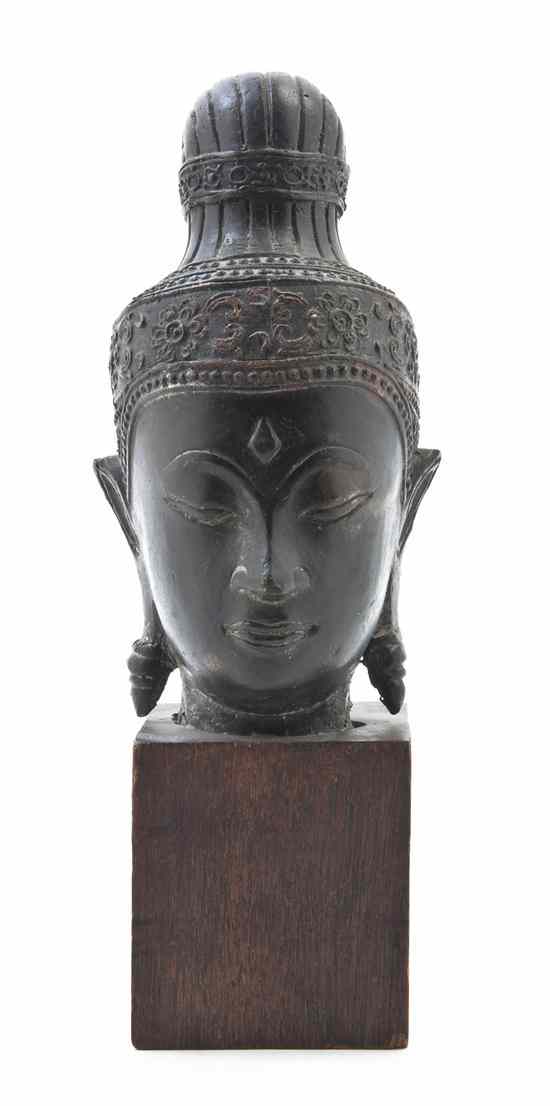 Appraisal: A Southeast Asian Bronze Head depicted with a serene expression