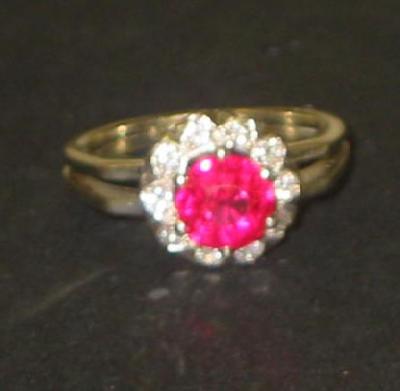 Appraisal: A RUBY AND DIAMOND CLUSTER RING the central round cut