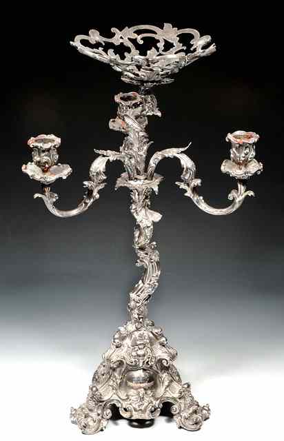 Appraisal: A SILVER PLATED CENTRE PIECE on tripod base heavily decorated