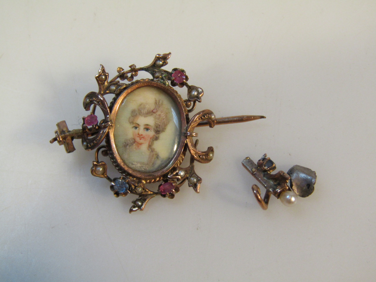 Appraisal: A late Victorian pendant brooch centred with a profile of