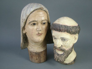 Appraisal: Two Continental carved wooden heads of Saints each with glass