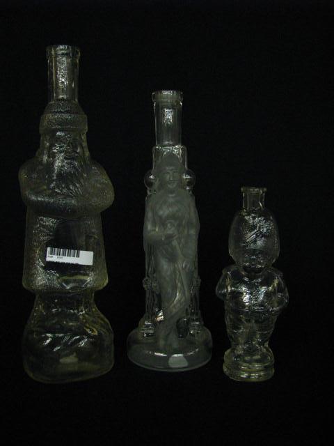 Appraisal: Three antique figural bottles including children in tree open pontil