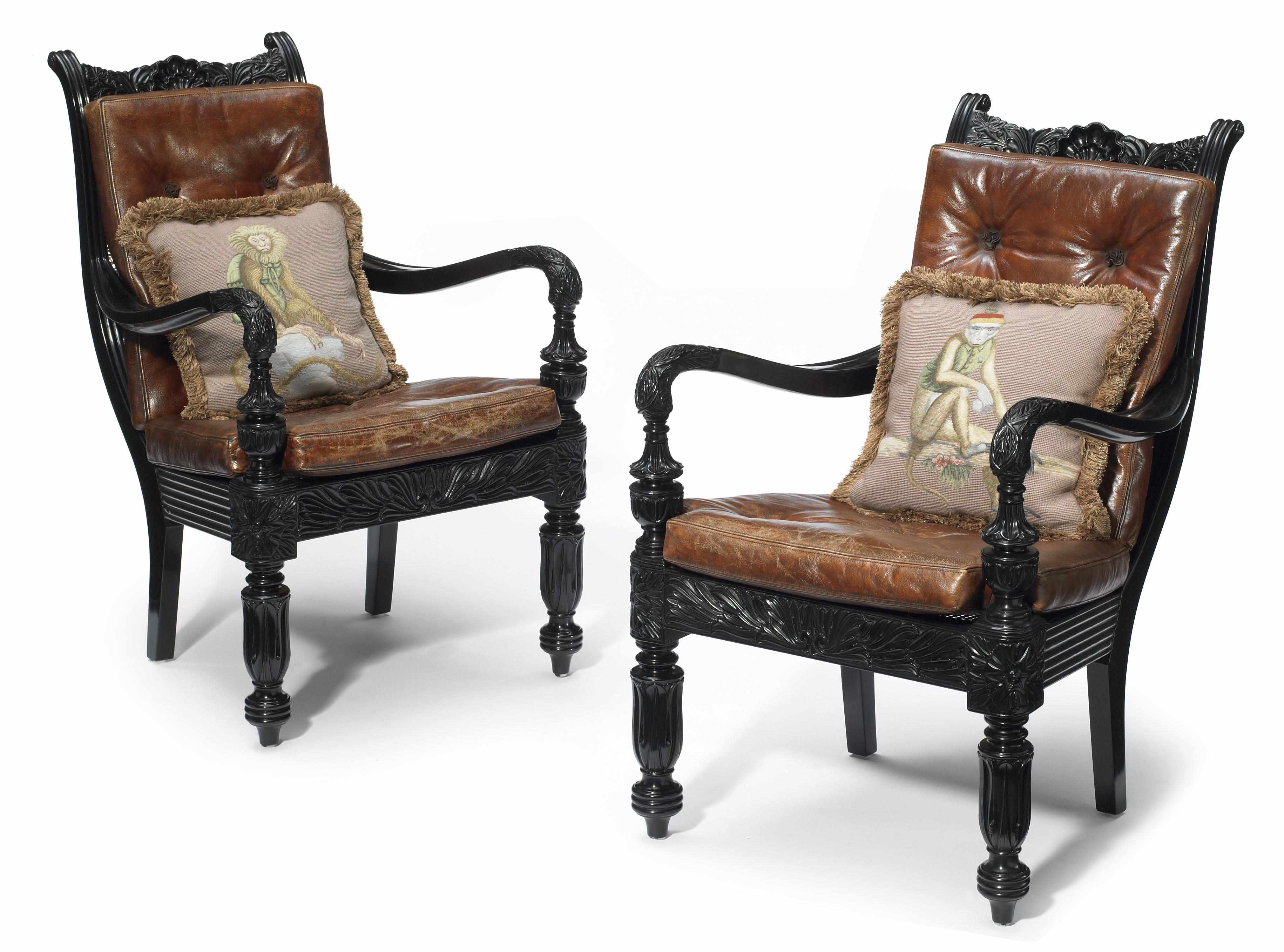 Appraisal: A pair of Anglo-Indian style carved ebonized library armchairs height