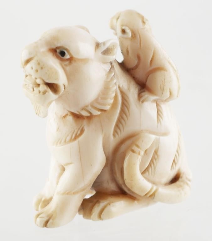 Appraisal: Carved ivory animal figure lioness and cub measures inches high