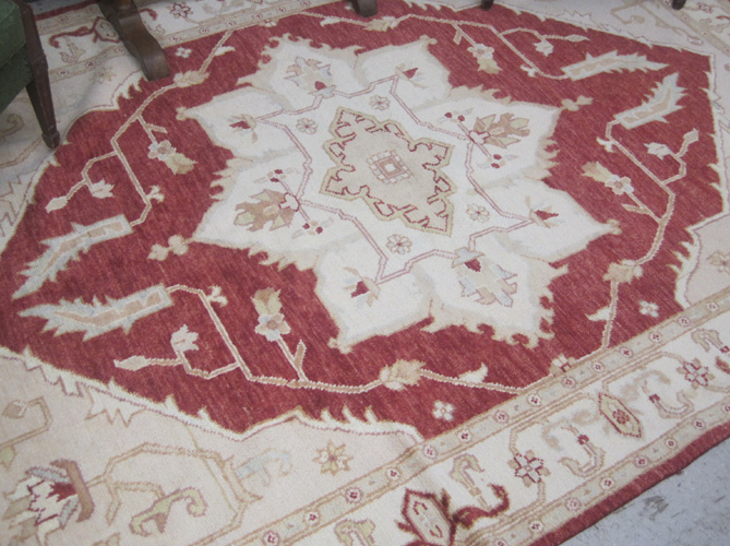 Appraisal: HAND KNOTTED ORIENTAL CARPET Pakistani Persian centering a large geometric