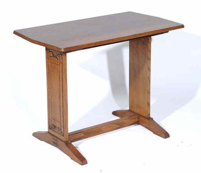 Appraisal: A COTSWOLD STYLE OAK CENTRE TABLE of rectangular canted form