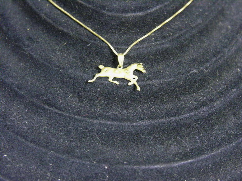 Appraisal: K GOLD NECKLACE WITH HORSE CHARM Size long chain Weight