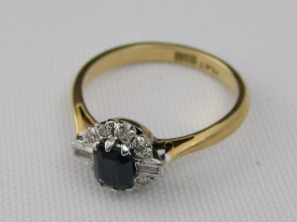 Appraisal: A Sapphire and Diamond Cluster Ring claw-set central step-cut sapphire