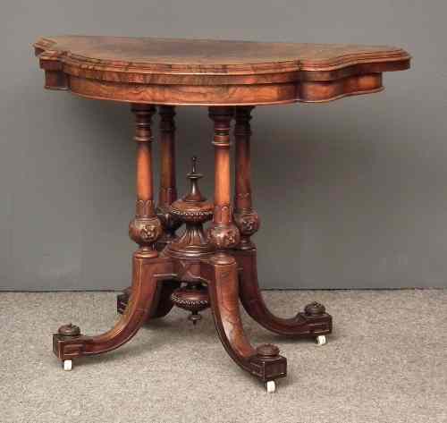 Appraisal: A Victorian figured walnut semi-circular card table with green baize