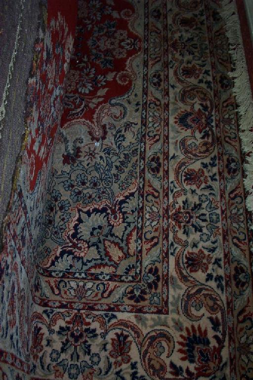 Appraisal: A large red ground wool carpet in the Eastern style