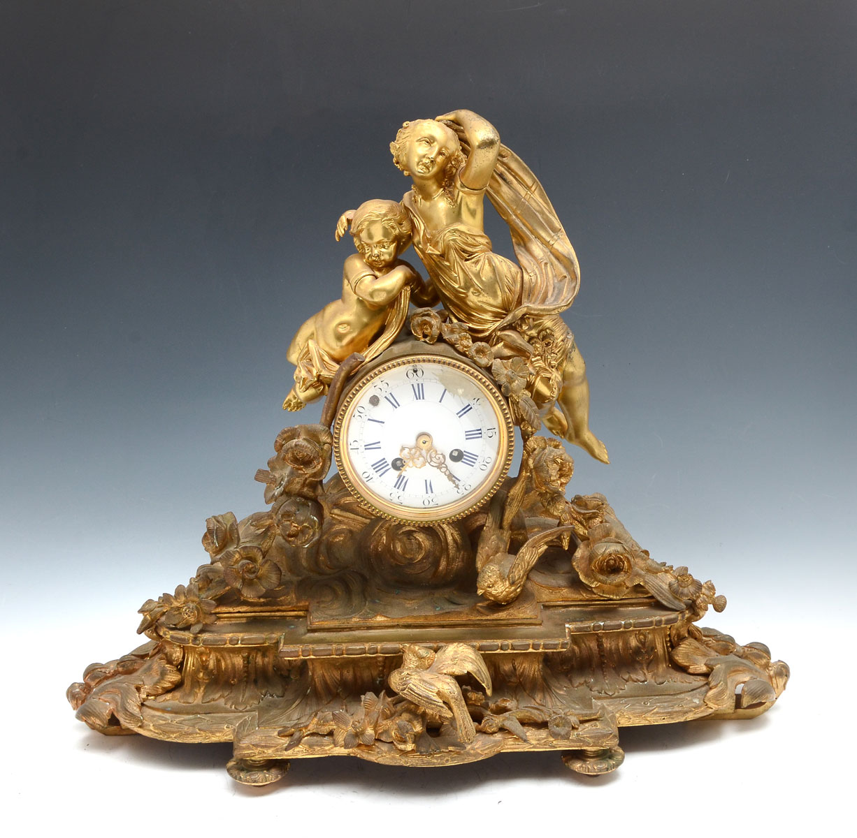 Appraisal: GILT FIGURAL MANTLE CLOCK Gilt mantle clock with a surmounting