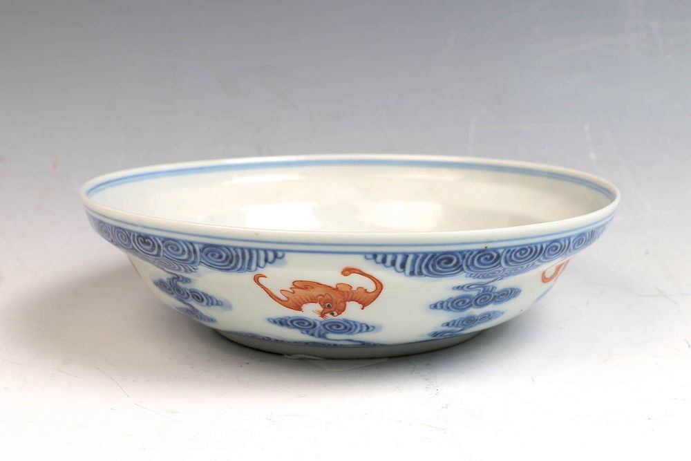 Appraisal: GUANGXU BLUE WHITE IRON-RED BAT DISH The shallow plate painted