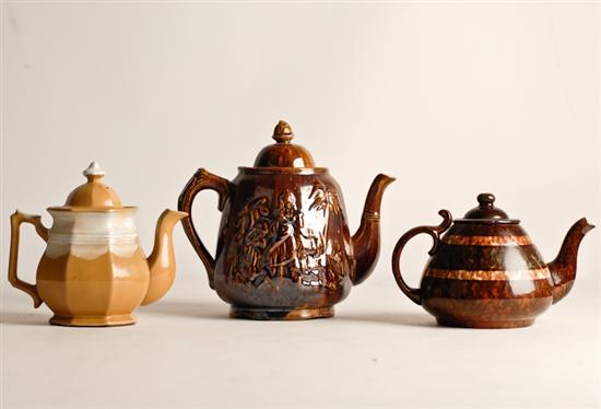 Appraisal: Three Pottery Tea Pots a Bennington pot with relief designs