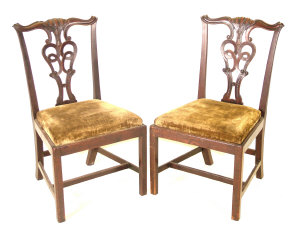 Appraisal: Two Georgian mahogany Chippendale style dining chairs the yoked carved