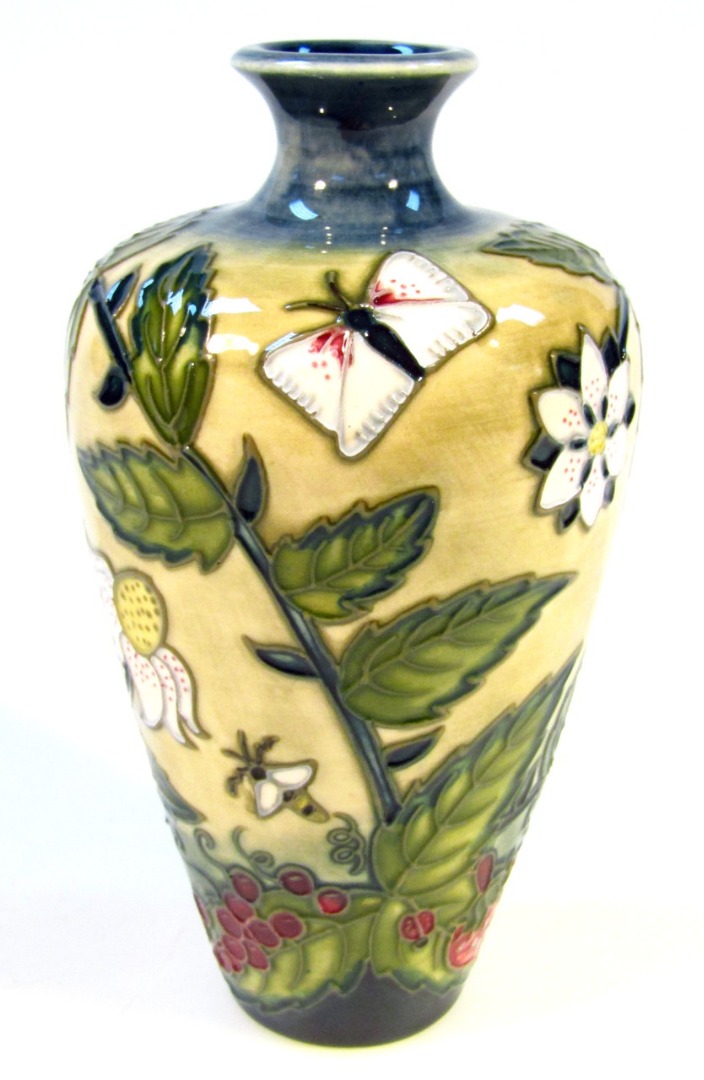 Appraisal: A Moorcroft Fruit Garden pattern pottery vase of circular shouldered