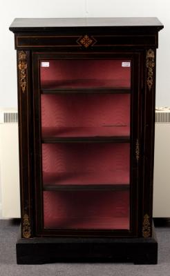 Appraisal: A Victorian ebonised display cabinet enclosed by a glazed door