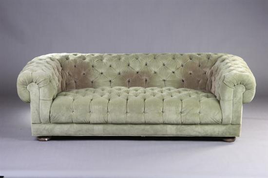 Appraisal: CHESTERFIELD STYLE BOX-FORM SOFA th century Over-scroll padded back continues