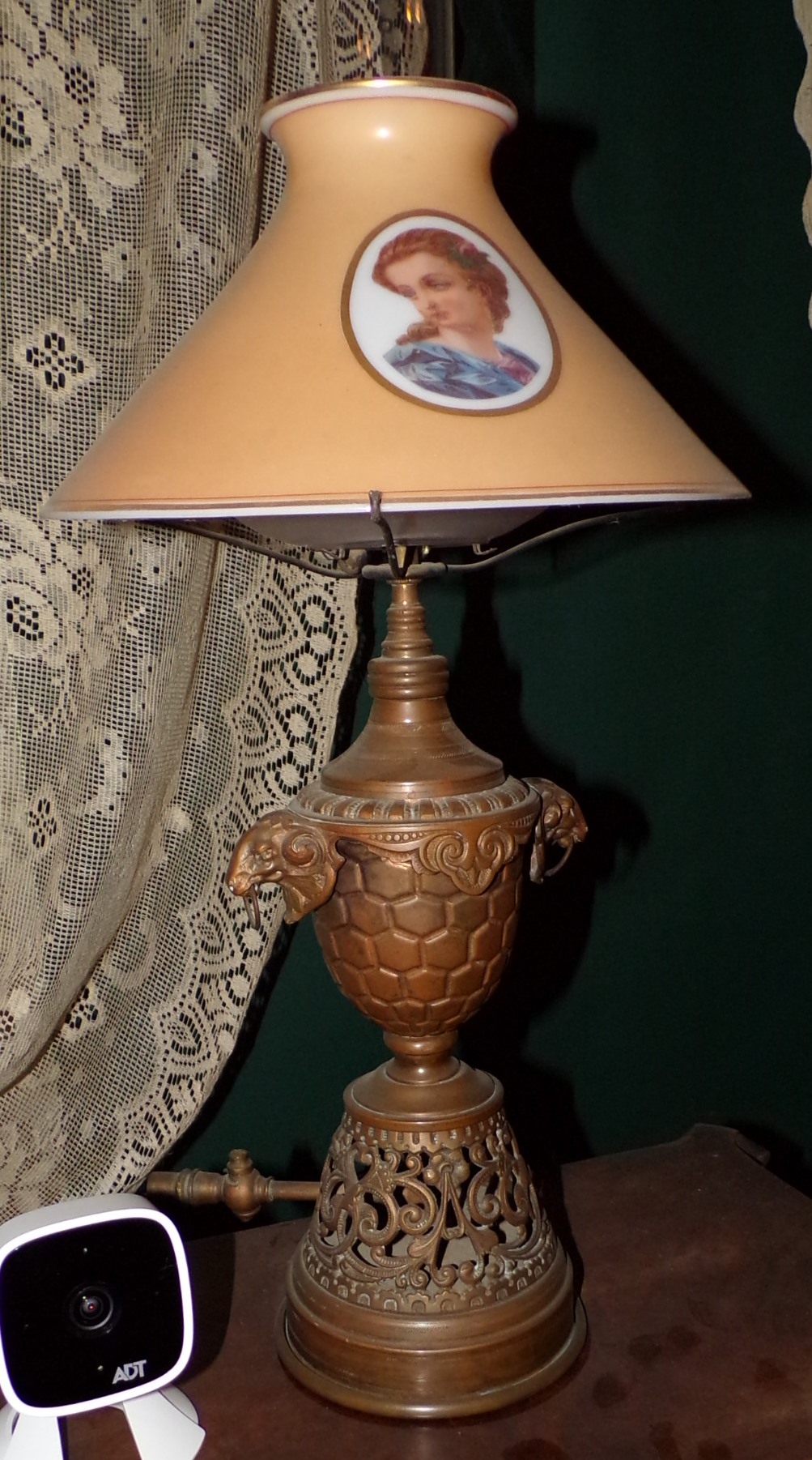 Appraisal: Bronze oil lamp electrified with glass shade shade ornamented with