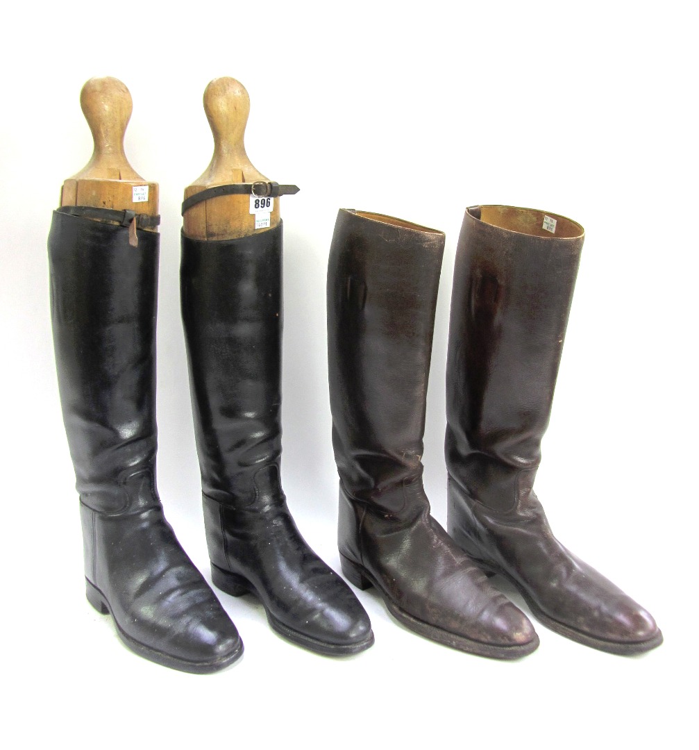 Appraisal: A pair of black leather riding boots and wooden lasts