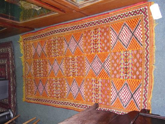 Appraisal: A TURKISH MULTI-COLOURED RUG with panels of geometric designs approximately