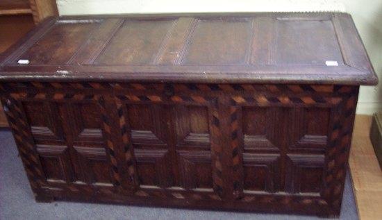 Appraisal: An oak chest the hinged cover set four panels with