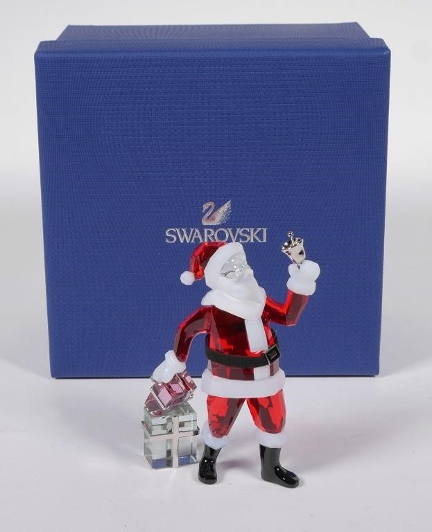 Appraisal: Retired Swarovski Santa Claus with bell and Christmas presents release