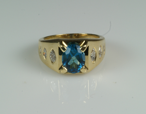 Appraisal: K YG blue zircon ring with diamonds down each shoulder