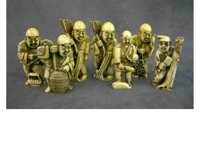 Appraisal: Seven flat ivory netsuke two depicting man with sticks tied