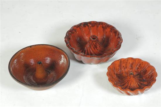 Appraisal: THREE REDWARE FOOD MOLDS American mid th century Two turk's