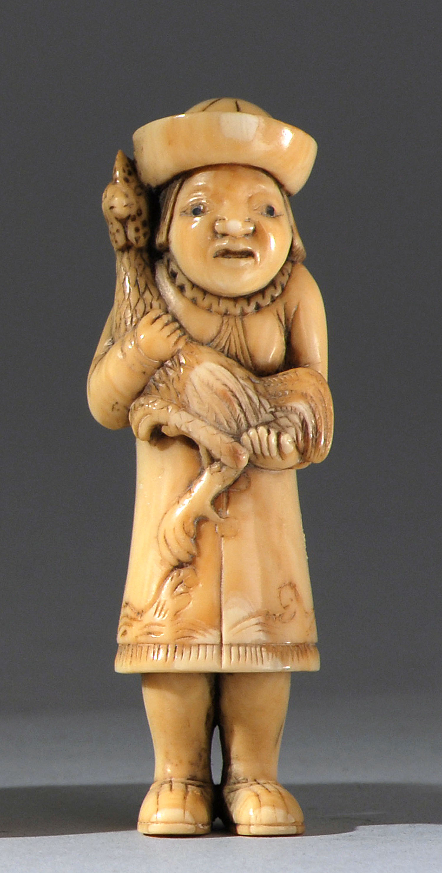 Appraisal: IVORY NETSUKE th CenturyIn the form of a Dutchman holding