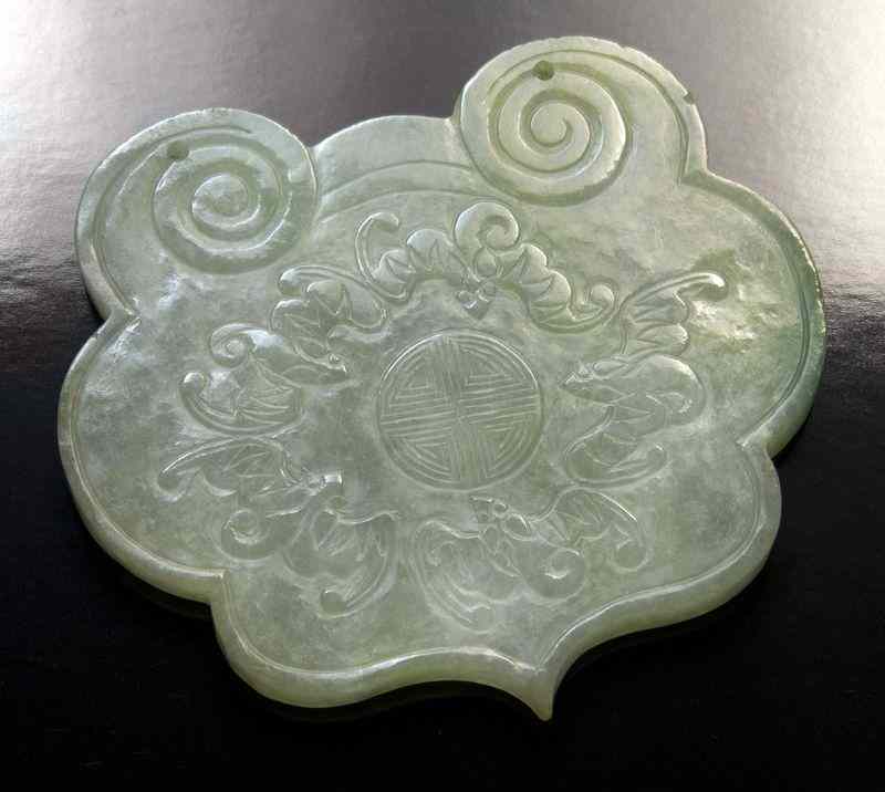 Appraisal: Chinese Qing carved jadeite plaquedepicting a peach and Buddha's hand