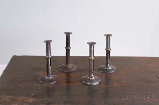 Appraisal: Four Iron Wedding Band Hogscraper Candlesticks England late th early