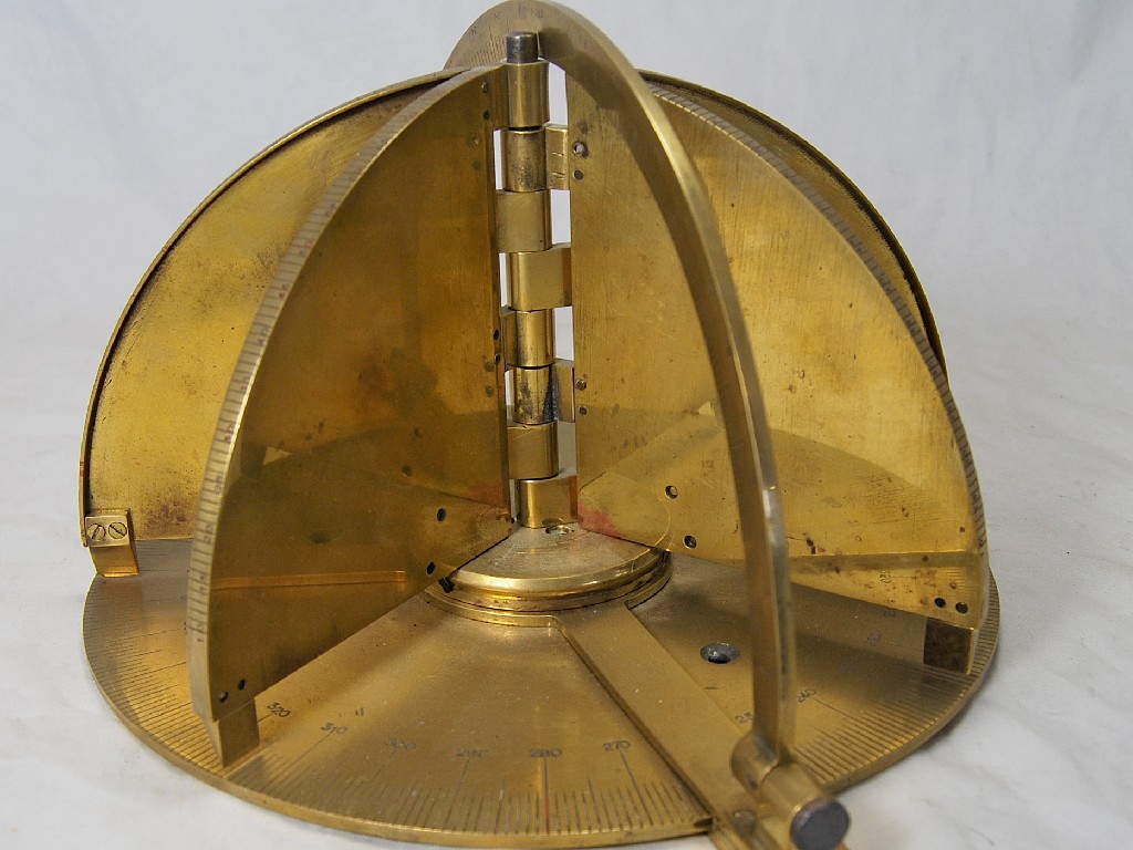 Appraisal: A brass navigational instrument with latitude and longitude scales and