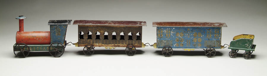 Appraisal: EARLY AMERICAN TIN TRAIN SET Train set with an engine