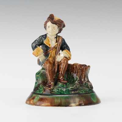 Appraisal: A Majolica Figural Match Holder Strike Molded as a boy