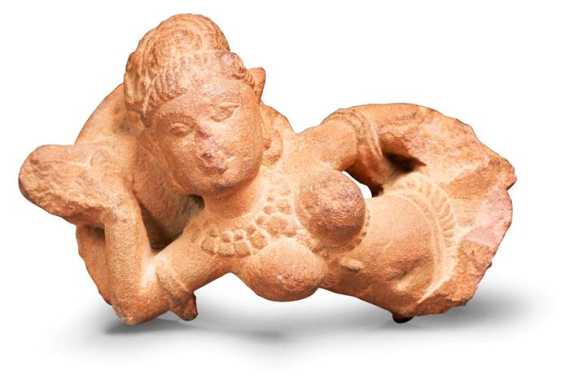 Appraisal: A SMALL SANDSTONE FRAGMENT OF A SMILING YAKSHI Central India