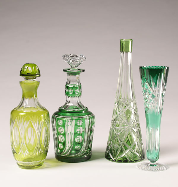 Appraisal: Bohemian green cut to clear glass vases and decanters Tallest