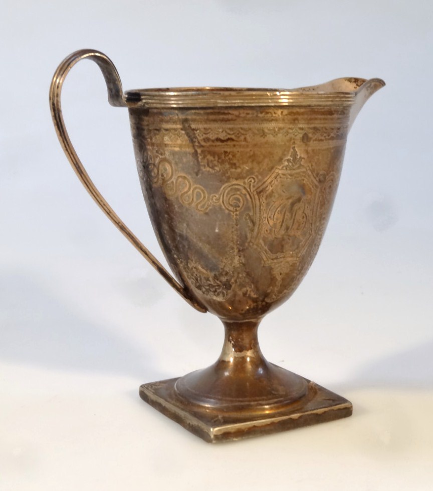 Appraisal: A George III silver cream jug the helmet shaped body