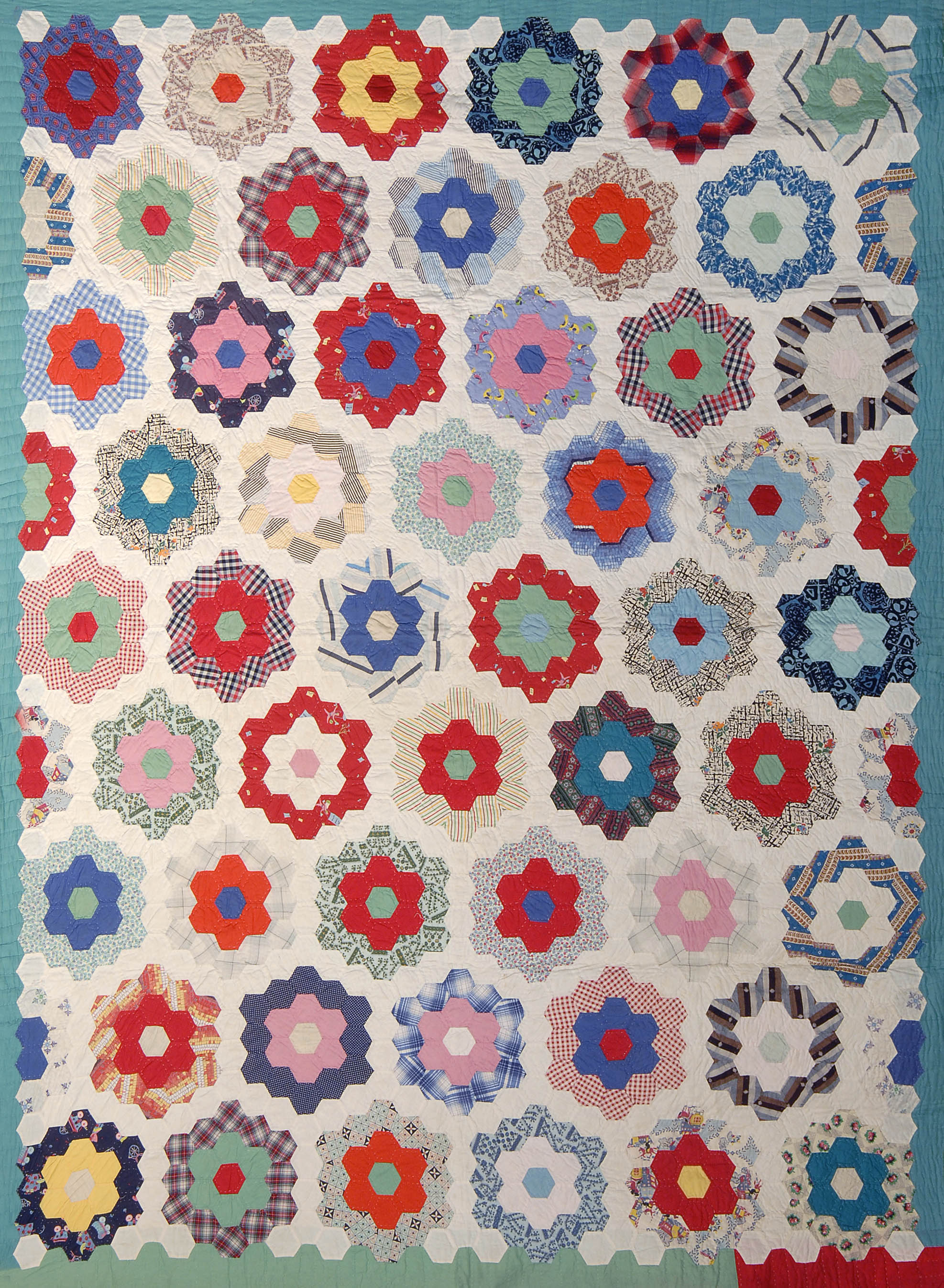 Appraisal: COTTON HAND-PIECED QUILT Circa Colorful patchwork flowers on a hand-stitched