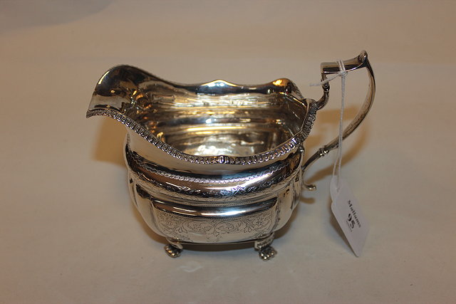 Appraisal: A GEORGE III IRISH SILVER MILK JUG with gadrooned edge