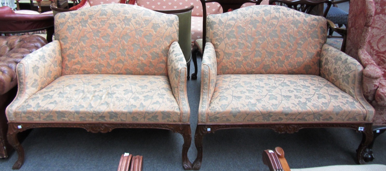 Appraisal: A pair of small walnut framed George II design sofas