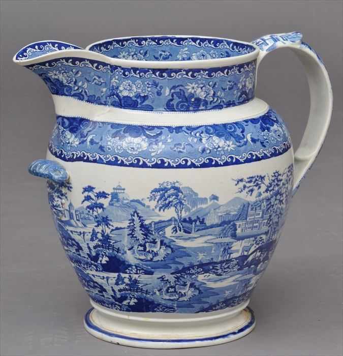 Appraisal: STAFFORDSHIRE BLUE TRANSFER-PRINTED MASSIVE PITCHER The ovoid bowl with two