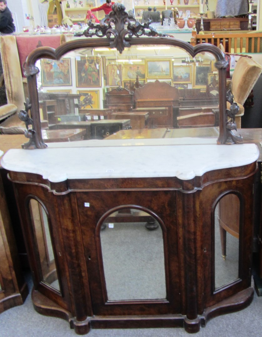 Appraisal: A Victorian figured walnut mirror backed marble top three drawer