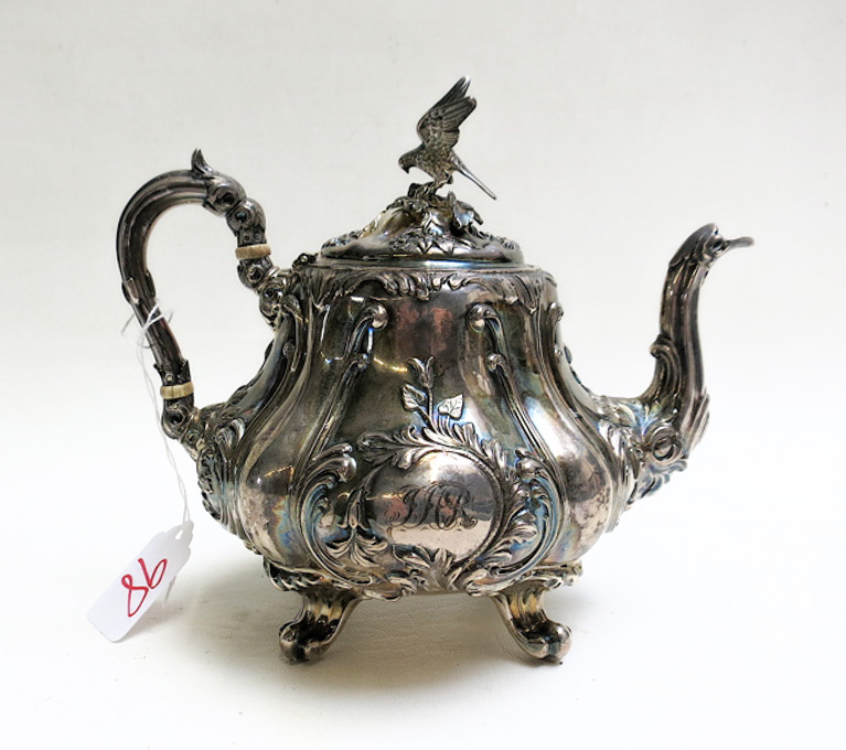 Appraisal: ENGLISH STERLING SILVER REPOUSSE TEAPOT with floral and foliage motif