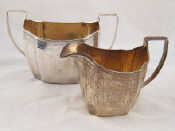 Appraisal: A Georgian silver cream jug and sugar bowl curve panelled