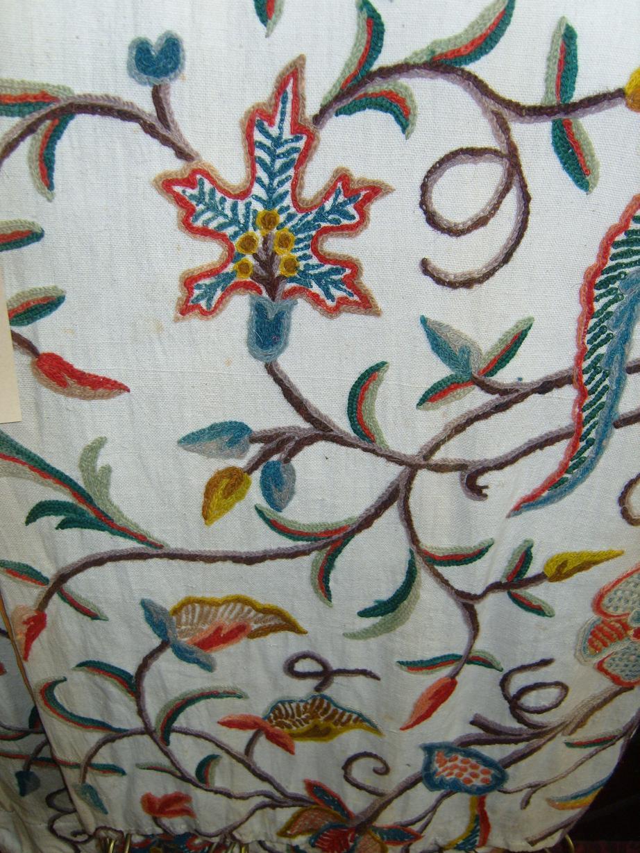 Appraisal: A pair of cream ground crewel work curtains with stylised