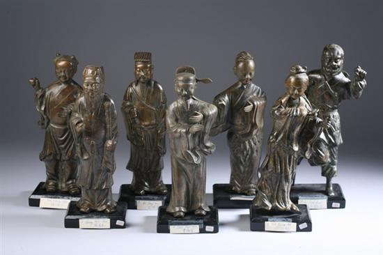 Appraisal: SEVEN CHINESE BRONZE FIGURES OF IMMORTALS Each standing wearing long